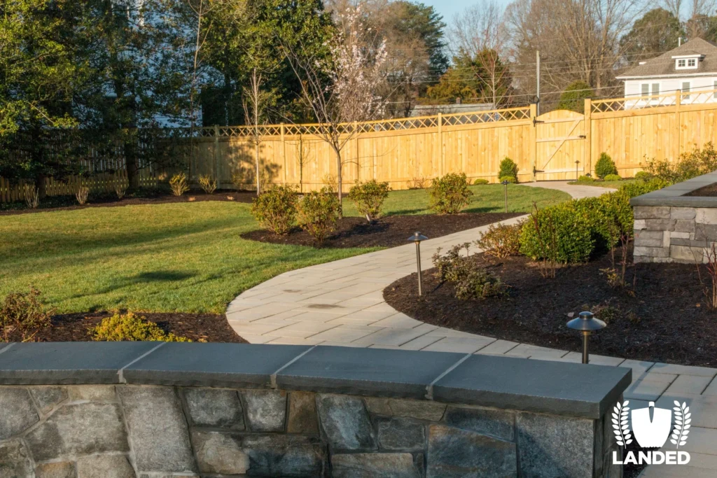 winding backyard pathway with sunshine hitting yard