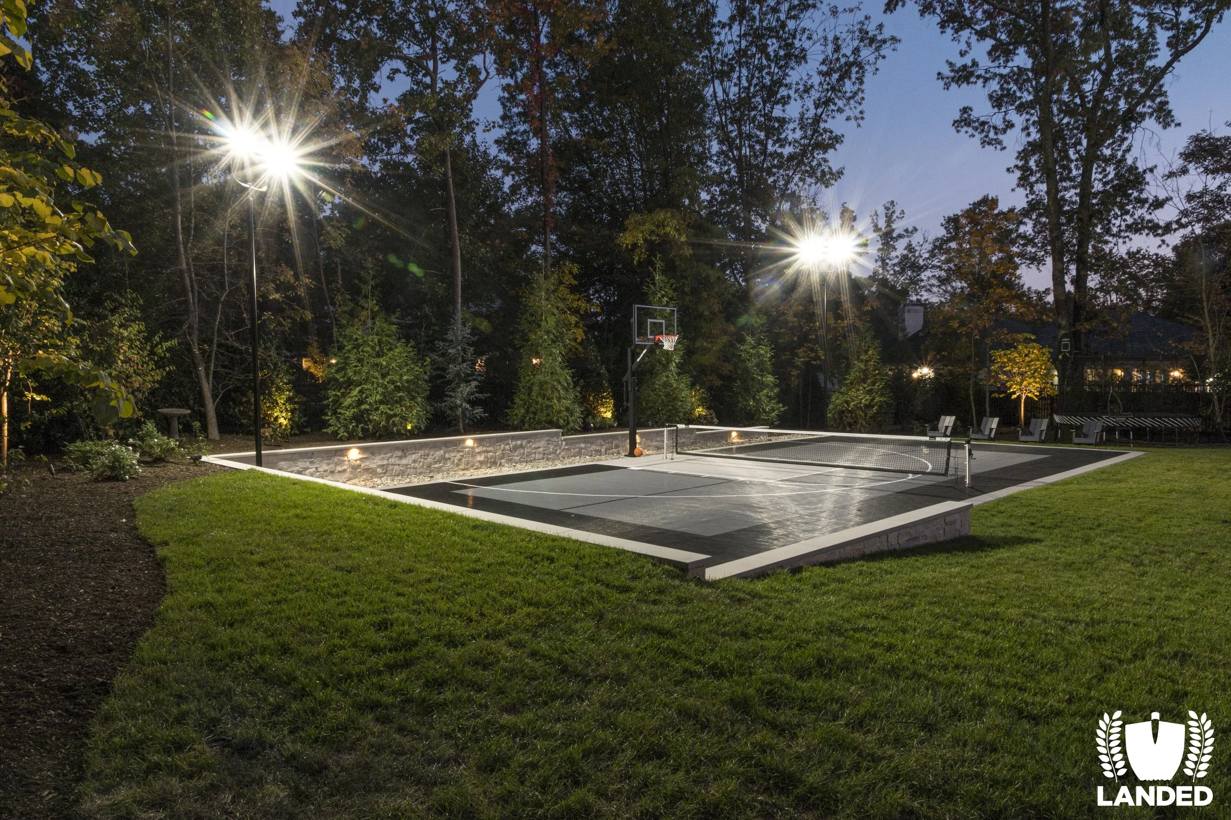 two spotlights on backyard sport court
