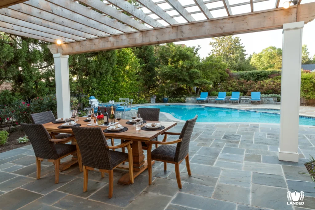 set table under pergola and next to pool