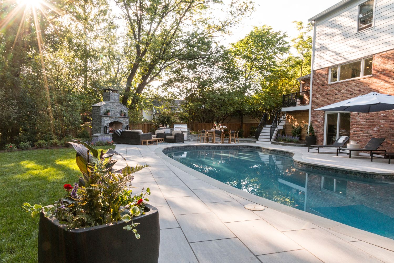 Layered plantings around a pool and outdoor living space in Northern Virginia